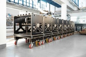 The picture shows eight transport trolleys of the "ligShuttle" model. They are used for in-plant transport in the automotive industry. Photo: PR/Ligenium
